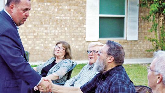 In 2019, Constable Precinct 4 hopeful Paul Leal (left) greets community members while visiting a block party for National Night Out. The event returns after two years Tuesday, Oct. 4. File photo