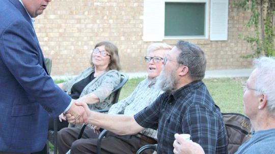 In 2019, Constable Precinct 4 hopeful Paul Leal (left) greets community members while visiting a block party for National Night Out. The event returns after two years Tuesday, Oct. 4. File photo