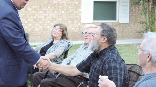 In 2019, Constable Precinct 4 hopeful Paul Leal ( left) greets community members while visiting a block party for National Night Out. The event ret u rns af ter two years Tuesday, Oct. 4.