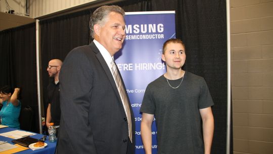 Williamson County Judge Bill Gravell chats with Hutto resident Kyle Spinder, who attended the Samsung Job Fair Sept. 1. Photos by Nicole Lessin