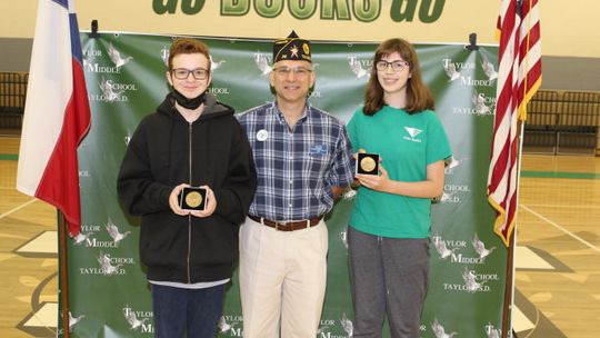 Mason Ruemke (left) and Elinor Brinkmeyer receive the American Legion Award at Taylor Middle School in Taylor May 26. Photo by Tim Crow