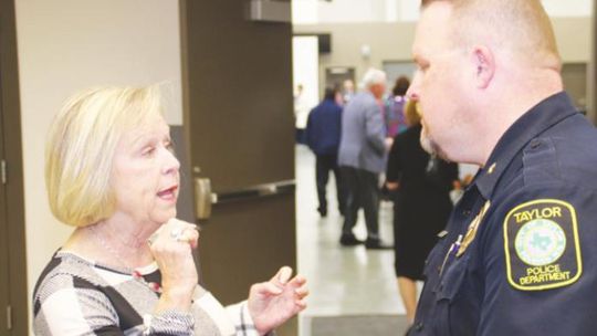 Woman of the Year Moppy Miller (left) takes a moment to talk to a former Taylor High School student, Commander Joseph Branson at the chamber awards banquet. Photo by Jason Hennington