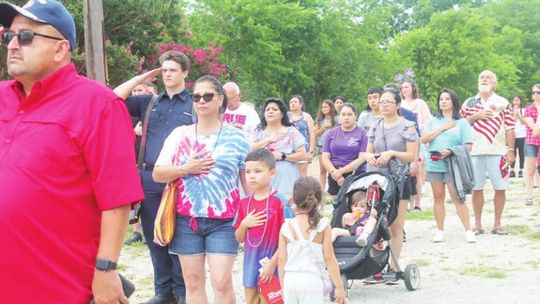 Dwayne Ariola (left) and others stand for the National Anthem at Independence Day festivities at Murphy Park in Taylor July 4, 2021. Photo by Fernando Castro