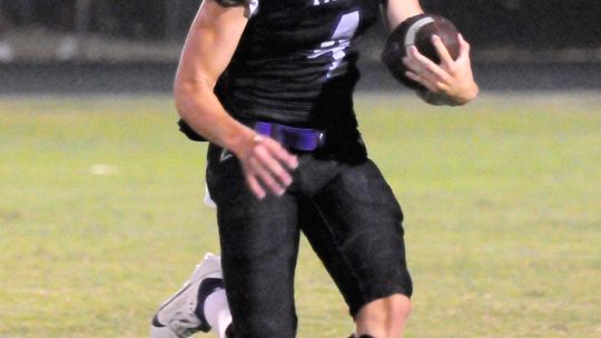 Thrall High School varsity football junior quarterback Chance Parker scrambles for yardage on Friday night during the Tigers’ 56-42 victory at home vs. Johnson City High School.  Photo by Larry Pelchat