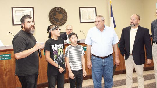 (Left) Jose Barraza addresses the crowd alongside sons Vincent and Adrian, Dan Doss, with the Williamson County Historical Commission, District 4 Councilman Robert Garcia, and Joe Burgess, chair of the Friends of the Moody Museum, during the reading of the “Pet Brown Day Proclamation” at t...