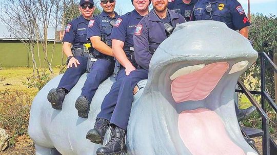 Hutto police officers are all in for World Hippo Day. They chose Henrietta for their celebratory photo.