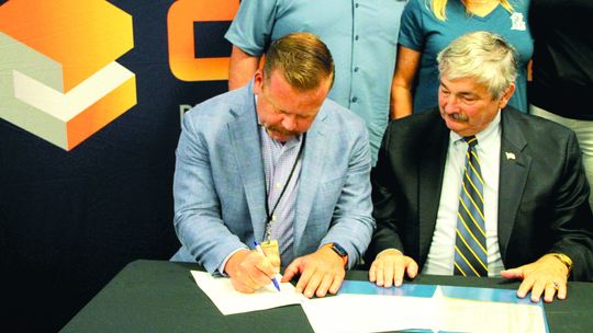 Sam Dowdy Jr. (left), owner and operator for Coppera Plumbing and Commercial Services, signs apprenticeship agreement next to Lee Price (right) of the Department of Labor. Photos by Hunter Dworaczyk