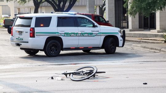 Police: Cyclist struck, dragged by car