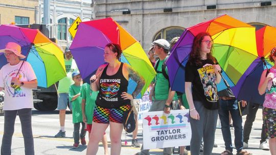 The Parasol Patrol and others listen to Mayor Brandt Rydell’s opening remarks at the Taylor PRIDE Festival in Taylor June 25. Photo by Fernando Castro