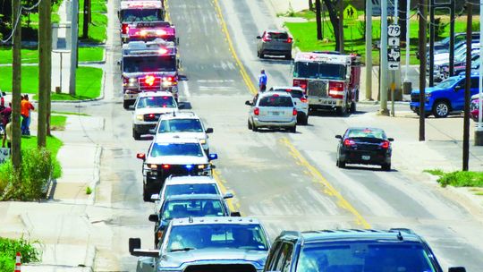 Service vehicles, including fire trucks from the area were a part of the processional for Taylor retired firefighter Robert Whitmore.