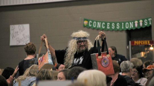 At-large councilman Dwayne Ariola models a purse up for grabs at the Designer Purse Bingo fundraiser Nov. 5 at the Williamson County Expo Center. Photo by Nicole Lessin