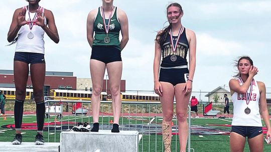 The Queen of Green Emma Whitsel (second from left) was area champion in the 100-meter hurdles and broke the school record once again running a 15.26 and advancing to the regional meet. Photos Courtesy Shelli Cobb and Earven Flowers