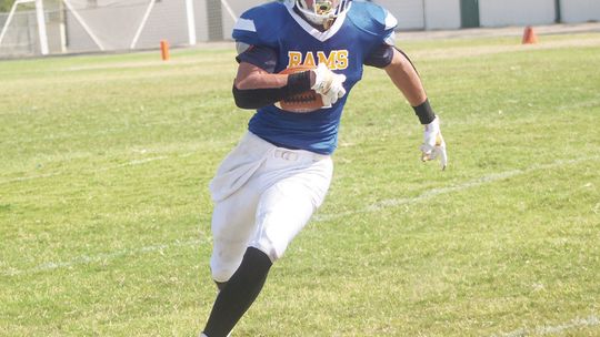 Rams varsity football junior running back Tyler Zimmerhanzel cuts upfield and gains extra yardage on Aug. 26 during St. Mary’s home game vs. Wilco Home School.