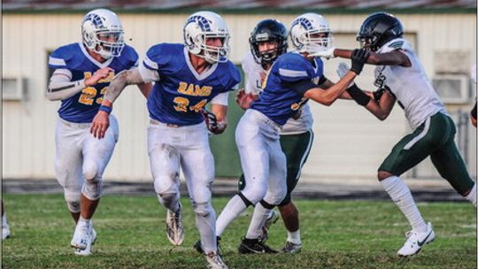 St. Mary’s Catholic School varsity football senior linebacker Brady Altman (34) and junior linebacker Kolbe Barta (23) look to make a stop defensively on Friday, Sept. 15 during the Rams’ home game vs. Arlington St. Paul’s Prep. Photo by Larry Pelchat