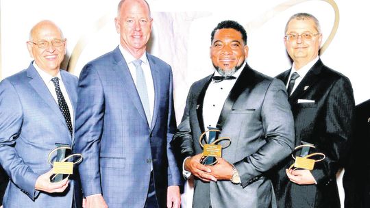 Hardy Jackson (third from right) along with other employees at Textron Systems receives an award for their outstanding contributions to the company.