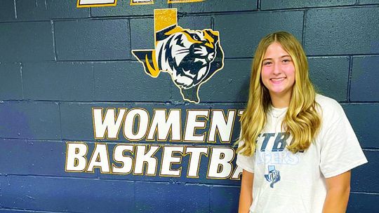 Taylor High School senior Ansley Reed happily poses for a photo over the weekend at the East Texas Baptist University women’s basketball facility in Marshall. Courtesy photo