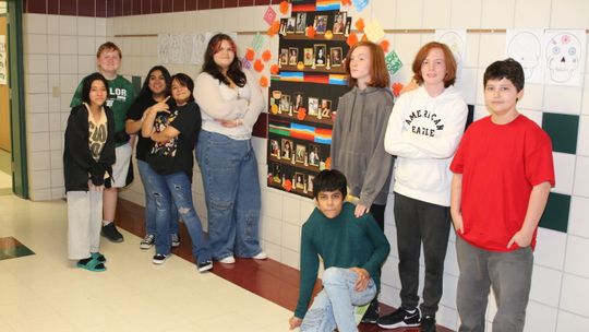 Students in Griselda Villalobos’ Spanish class at Taylor Middle School prepared a Day of the Dead altar in the hallway, including photos of icons and family members who have passed. Photo by Tim Crow