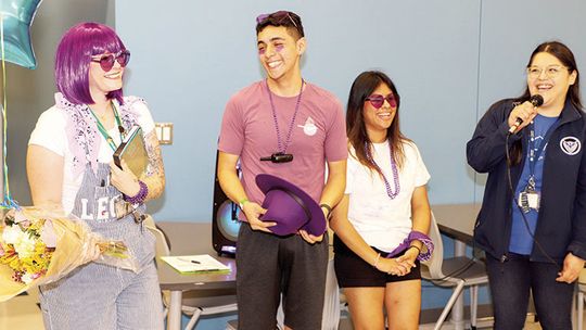 Legacy Teacher of the Year, Kelly Windham (far left), is congratulated by students Sergio Ibarra (center left) and Wendy Ibarra Santibanes (center right) and Principal, Erika Elizondo (far right). Photo by Tim Crow