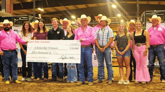 Texas Rodeo Association scholarship winners along with the TRA board members presenting the total check. Each of the ten recipients will receive $5,000 to cover tuition. Photos By Edie Zuvanic