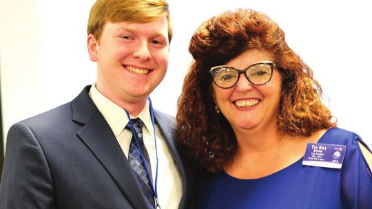 Rotary Club of Taylor president Tia Rae Stone presents the 2022 Bunnell-Rotary Academic Scholarship for $6,000 to Taylor High School graduating senior Trey Boles during a May 2 banquet in Taylor. Boles is the son of Renee Boles and Jarrell Boles. Photo by Richard Stone