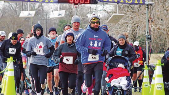 Runners take off into the chilly Saturday morning wind last year at the Taylor Garden Club Run for the Roses 5K/10K. Photo by Matt Hooks