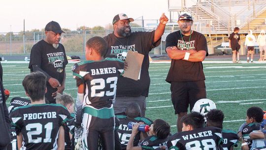 This past November, during the Tri-County Youth Football League Super Bowl, Quincy Griffin motivates and encourages his team. Photo by Evan Hale