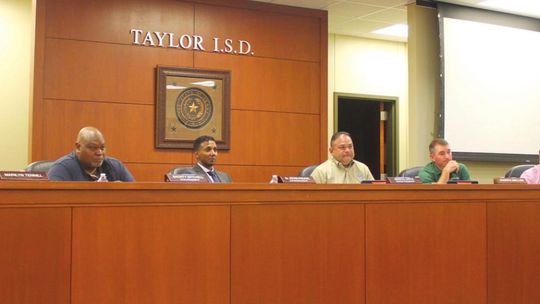 Marilyn Tennill, Shorty Mitchell, Superintendent Devin Padavil, board president Marco Ortiz, Joseph Meller, Jim Buzan and Cheryl Carter hear from residents during a public hearing during their Taylor ISD school board meeting in Taylor May 24. Photo by Fernando Castro