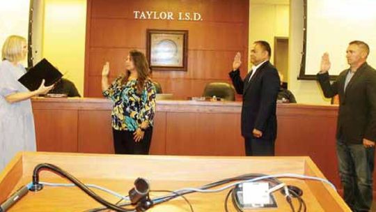 Vicki Roth (left) administers the oath of office for returning and new Taylor ISD board members Cheryl Carter, Marco Ortiz and Joseph Meller during the board’s meeting in Taylor May 16.