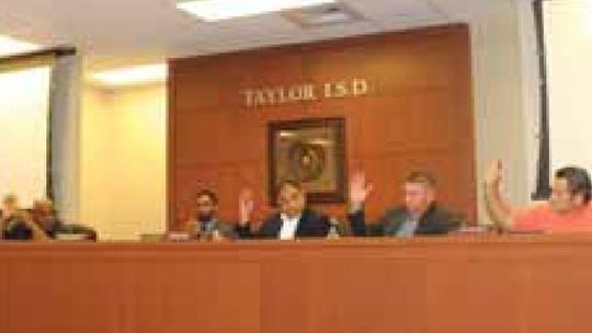 Continuing and new Taylor ISD school board members take one of their first votes in their new configuration during their meeting in Taylor May 16. Photo by Fernando Castro