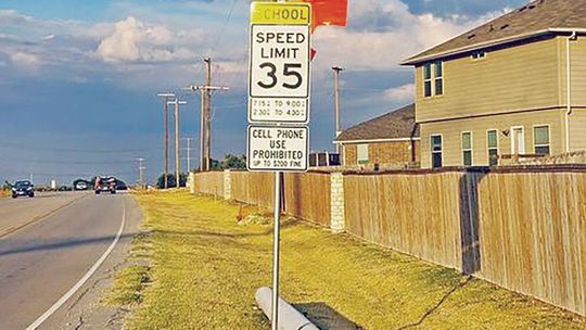 Orange flags alert drivers to a new school zone added along Limmer Loop in Hutto. Facebook / City of Hutto, Texas - Municipal Government