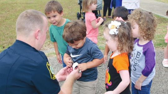 Taylor ISD school resource officer Jacob Loeve visits with students at the district’s child development center about his job in this October 2019 photo. Photo by Tim Crow