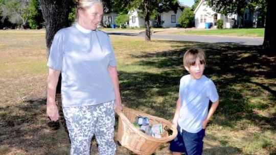 The Rev. Terry Pierce of St. James Episcopal Church helps her godson deliver a basket of donations. Courtesy photos