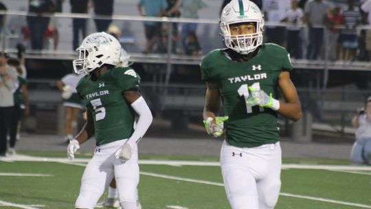 Anderson and Richardson getting to their positions on the field during a game. Photo by Jason Hennington