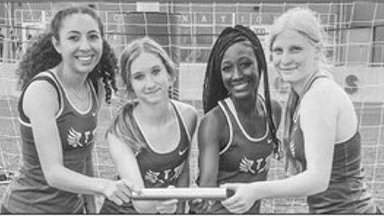 Lady Ducks 4x200 M Relay team Azalie Balusek, Zakaya Frederick, Kaleigh Woods, Emma Whitsel taking a picture after winning the district championship. Courtesy Photo