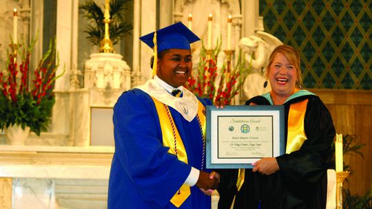 Salutatorian Daniel Vincent recieved his Salutatorian Award from Head of School Heidi Altman with a handshake and a chuckle at the Class of 2023 Commencement Ceremony Thursday, May 25, at St. Mary of the Assumption Catholic Church.