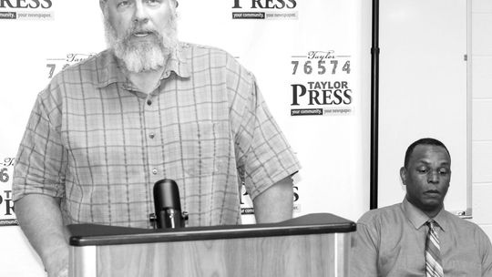 Gerald Anderson (right) watches as Stan Werner addresses the community during the candidate forum held April 12. Photo by Fernando Castro