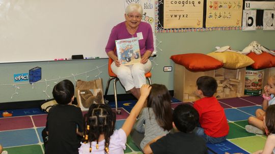 In memory of Naomi Pasemann, Darlene Rydell reads one of Pasemann’s favorite books, The Rattle Trap Car, to a kindergarten class at TH Johnson. Photos by Tim Crow