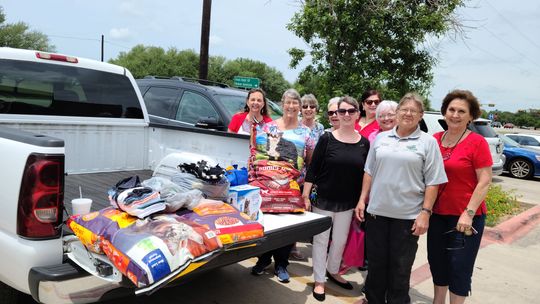 Sandy Perio (front), Taylor Animal Shelter manager, accepts donations from the Taylor Area Businesswomen.   Courtesy photo