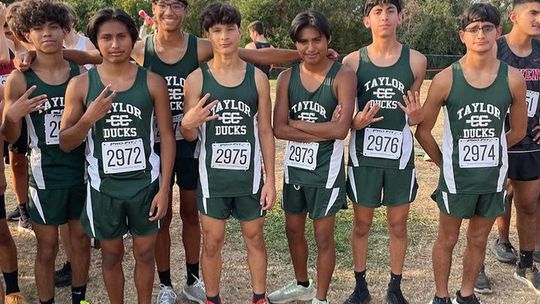 The Taylor High School boys varsity cross country team happily gathers together for a photo on Friday morning during the Vista Ridge Invitational meet held in Cedar Park. Photo courtesy of Taylor Athletic Booster Club. 