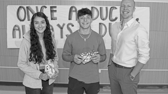 Ryan Schneider (Right), of RE/MAX Associates Group, congratulates Taylor High School Students of the Month, Estrella De La Torre (left) and Ryan Valdez (center). Photo by Tim Crow