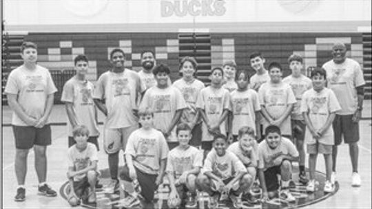 The Ducks sixth through ninth-grade group poses for a photo at the Taylor High School main gym on June 15 following the Boys Summer Basketball Camp. Photo by Andrew Salmi