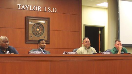 Marilyn Tennill, Shorty Mitchell, Superintendent Devin Padavil, board president Marco Ortiz, Joseph Meller, Jim Buzan and Cheryl Carter hear from residents during a public hearing during their Taylor ISD school board meeting in Taylor May 24. Photo by Fernando Castro