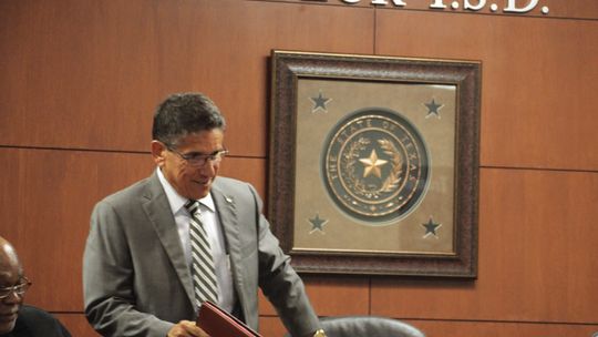 Steve Flores, who was named as the interim superintendent at the Aug. 7 special school board meeting of the Taylor Independent School District,, ceremoniously joins the trustees. Photo by Hunter Dworaczyk