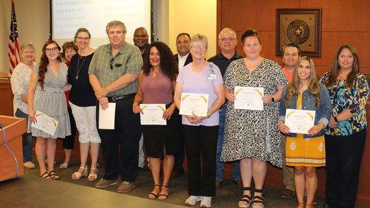 Taylor ISD school board members congratulate the district’s Teachers of the Year. Award recipients from left are Jennifer Lindquist, Jean Barnett, Trent Whitney, Cynthia Rios, Lynn Bedard, Briana Bohac and Laura Sanchez. Photo by Tim Crow