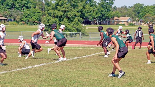 The Taylor High School varsity football defense surveys the field and looks to make a play against Lago Vista High School on June 10 during the 7-on-7 state qualifying tournament held at the track stadium in Cameron. Photos by Andrew Salmi