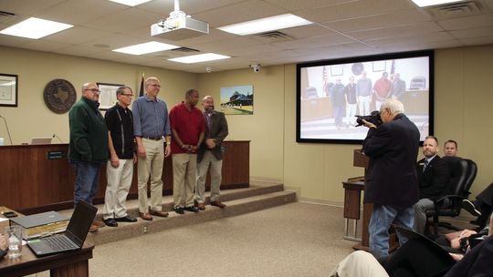 Former White House Photographer David Valdez shoots a photo of the Taylor City Council Oct. 27, at their regular meeting. Photo by Nicole Lessin