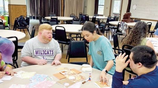 Taylor High School student, Bethany Elms, visits with friends at Down Home Ranch during a Day of Service. Courtesy photos