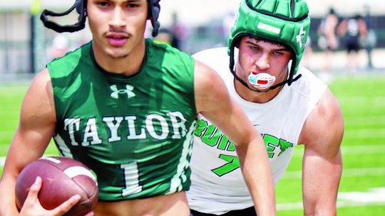 Taylor varsity football senior Kayden Land outruns an opposing player on Saturday during the Ducks’ 7-on-7 scrimmage against Burnet.