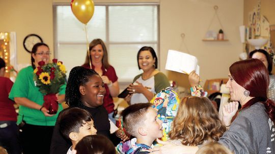 Naomi Pasemann Elementary Teacher of the Year, Jennifer Tobler (far right) is congratulated on her award by her students. Photo by Tim Crow