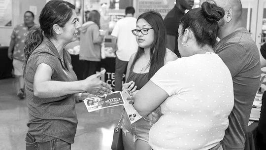 Dr. Eva Munguia, executive director of student success and HSI STEM program director, assists students and their families during the 2022 Open House in Hutto. Photo by Steve Lemmons